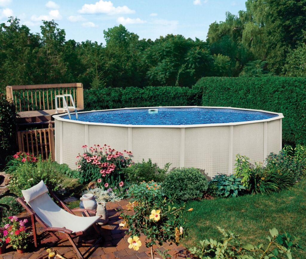 Why You Should Stock Up On Pool Supplies Before Summer 8 This is an above-ground pool in a backyard setting surrounded by landscaping and a small deck