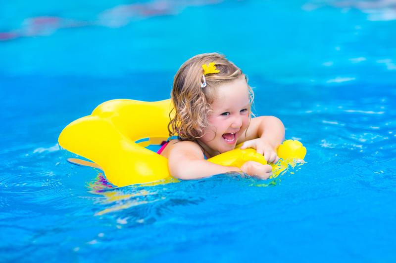 Searching for 'Pool Supplies Near Me'? Here’s What to Know 2 Pool supplies near me. A girl on a yellow pool float swimming in a pool.
